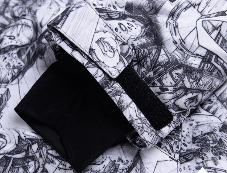 Close-up of waterproof ski jacket sleeve showcasing artistic black-and-white design, velcro strap, and windproof fabric.